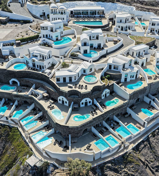 Aerial view of Grand Ambassador by Trend Hotels with luxury suites and private pools overlooking the caldera