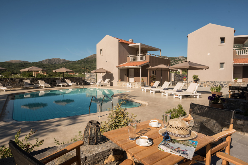 Relaxing pool area at Avdou Collection by Trend Hotels with mountain views and sun loungers in Crete